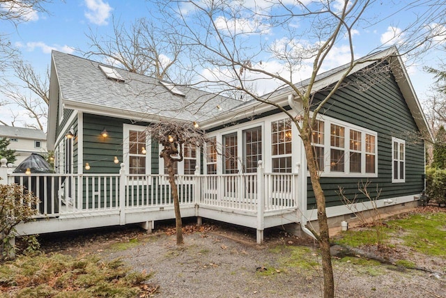 back of property with a wooden deck