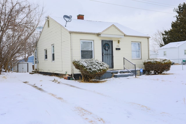 view of front of property with a shed