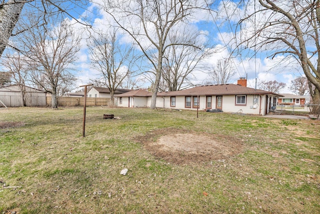 22810 E 13 Mile Rd, Saint Clair Shores, MI 48082 - back of property with an outdoor fire pit and a chimney