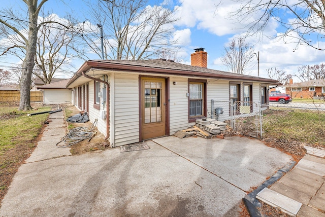 22810 E 13 Mile Rd, Saint Clair Shores, MI 48082 - rear view of property featuring a chimney and a patio