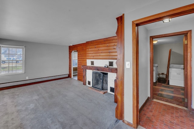 22810 E 13 Mile Rd, Saint Clair Shores, MI 48082 - unfurnished living room featuring washer / dryer, wood walls, a fireplace, baseboards, and carpet floors