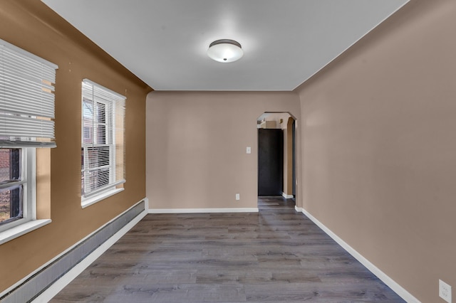 22810 E 13 Mile Rd, Saint Clair Shores, MI 48082 - spare room featuring arched walkways, wood finished floors, and baseboards