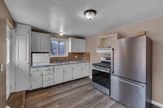 22810 E 13 Mile Rd, Saint Clair Shores, MI 48082 - kitchen with stainless steel appliances, a sink, white cabinets, light wood-style flooring, and range hood