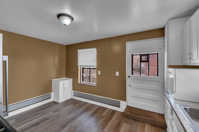 22810 E 13 Mile Rd, Saint Clair Shores, MI 48082 - unfurnished dining area with dark wood-style flooring, a sink, baseboards, and baseboard heating