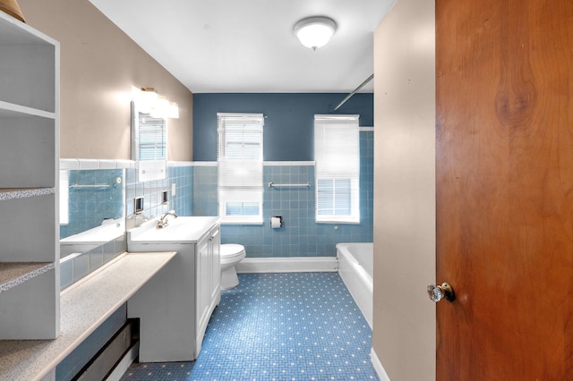 22810 E 13 Mile Rd, Saint Clair Shores, MI 48082 - full bathroom with toilet, tile walls, a wainscoted wall, vanity, and a bathtub