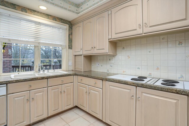 kitchen featuring a sink, decorative backsplash, white electric stovetop, and dishwasher