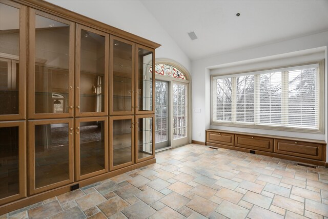 interior space featuring vaulted ceiling and visible vents