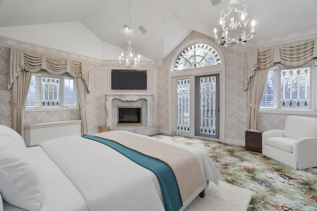 bedroom featuring a chandelier, multiple windows, a high end fireplace, and vaulted ceiling