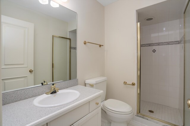 full bathroom with vanity, toilet, and a shower stall