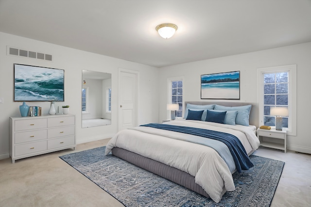 bedroom with light colored carpet, visible vents, and baseboards