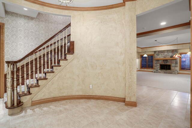 stairs featuring baseboards, wallpapered walls, recessed lighting, a fireplace, and ornamental molding