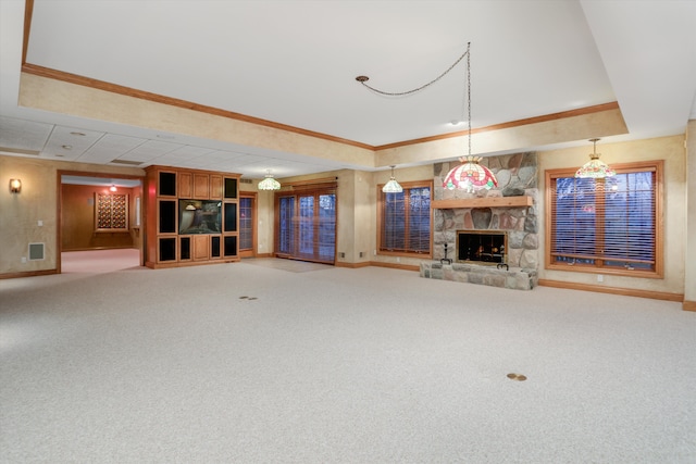 unfurnished living room with a stone fireplace, a raised ceiling, carpet, and ornamental molding