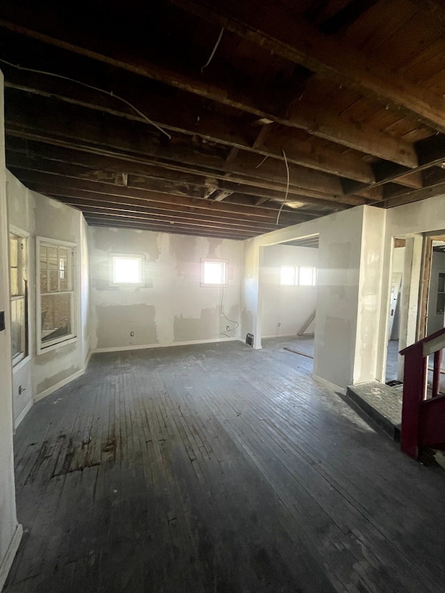 basement with dark hardwood / wood-style flooring