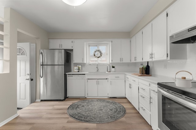 kitchen featuring white cabinetry, sink, light hardwood / wood-style flooring, and appliances with stainless steel finishes