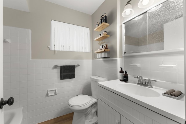 full bathroom with vanity,  shower combination, tile walls, and toilet