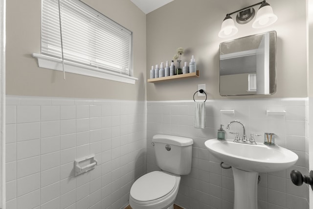 bathroom with tile walls and toilet