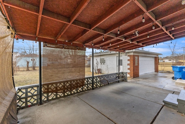 view of patio featuring a garage and an outdoor structure