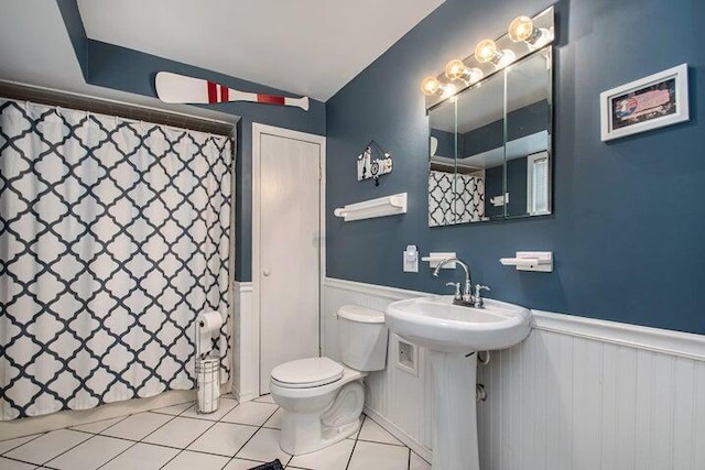 bathroom featuring tile patterned floors, toilet, and sink