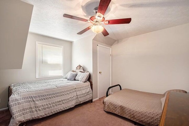 carpeted bedroom with ceiling fan and a textured ceiling