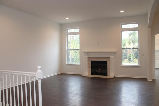 unfurnished living room featuring dark hardwood / wood-style floors