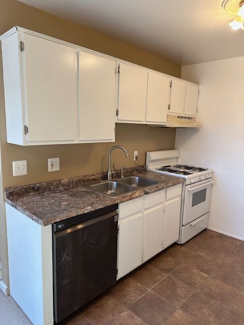 kitchen with sink, black dishwasher, white range with gas stovetop, and white cabinets