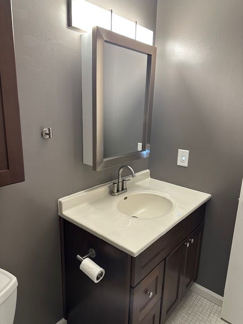 bathroom featuring vanity and toilet