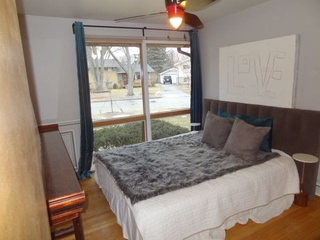 bedroom with wood-type flooring and ceiling fan