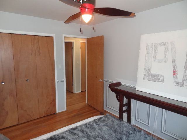 bedroom with hardwood / wood-style flooring, a closet, and ceiling fan