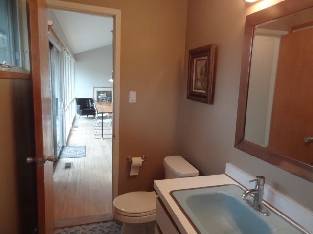 bathroom featuring lofted ceiling, vanity, and toilet