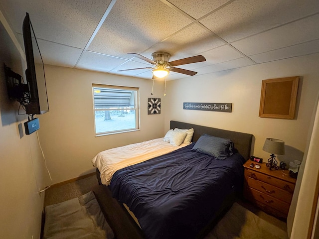 bedroom featuring ceiling fan and a paneled ceiling