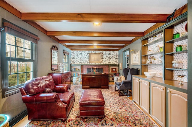 living room featuring beam ceiling and a fireplace