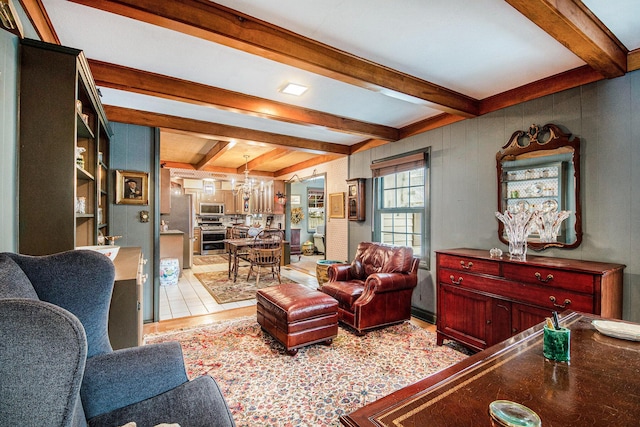 living room featuring a notable chandelier and beamed ceiling