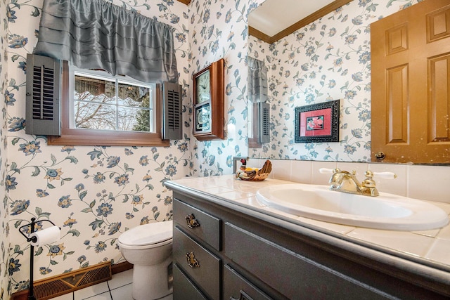 bathroom with vanity, ornamental molding, tile patterned floors, and toilet