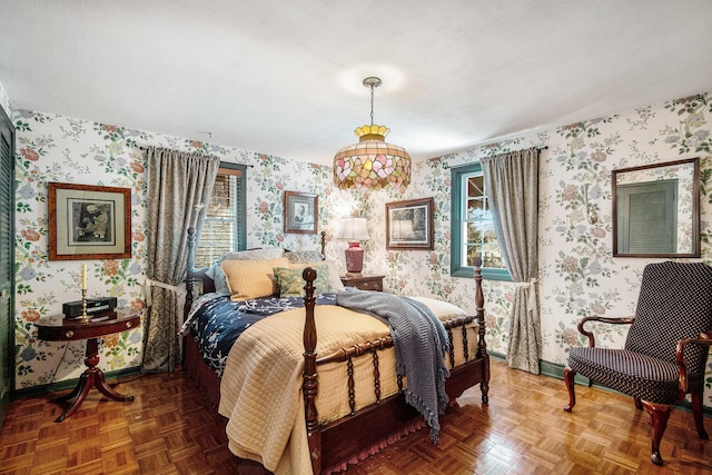 bedroom featuring multiple windows and parquet flooring