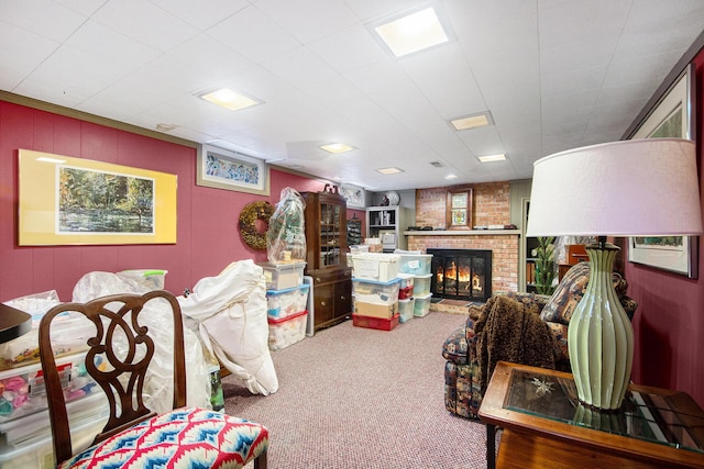 living room featuring carpet and a brick fireplace