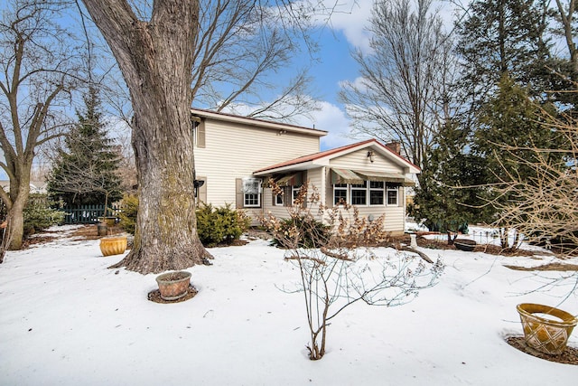 view of snow covered rear of property