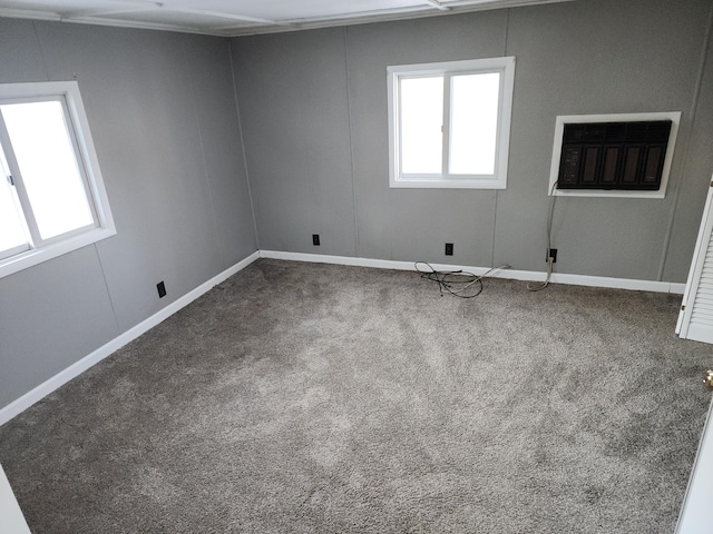 empty room with a wall mounted AC and carpet floors