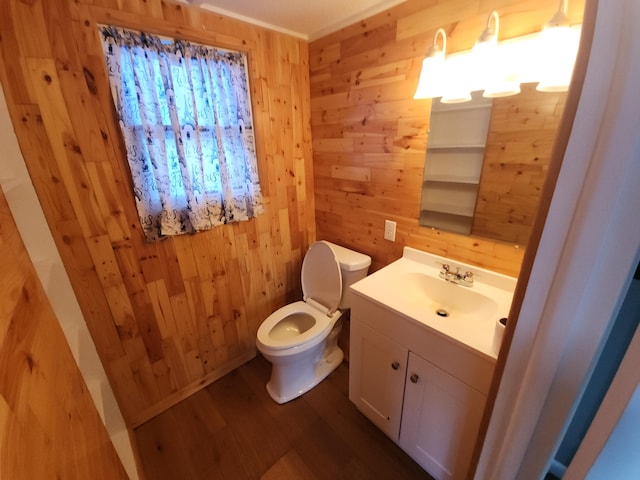 bathroom with vanity, wood-type flooring, wooden walls, and toilet