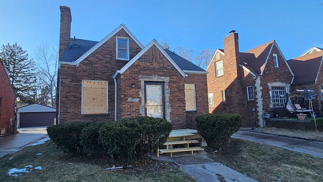 view of front of home with a garage and an outdoor structure