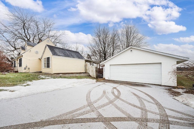 view of side of home with a garage and an outdoor structure