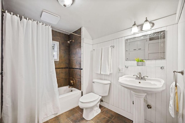 bathroom with shower / tub combo, tile patterned floors, and toilet