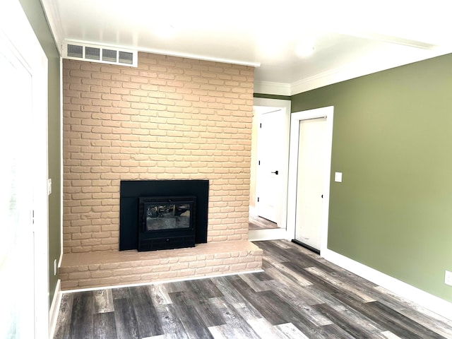 unfurnished living room with crown molding, a brick fireplace, and dark wood-type flooring