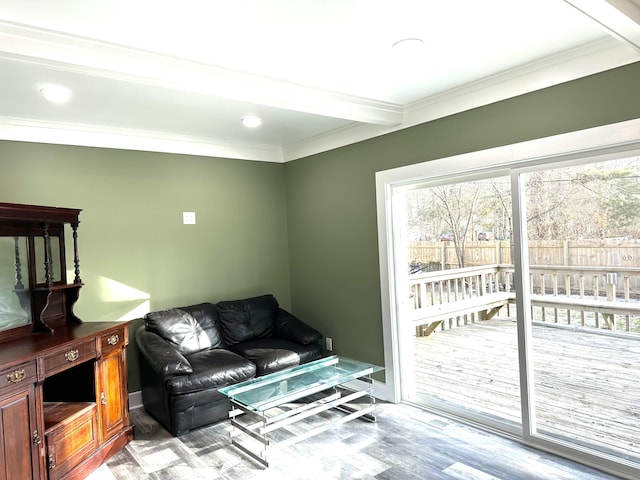 living room with crown molding, light hardwood / wood-style flooring, and beamed ceiling