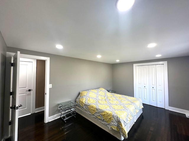 bedroom featuring dark hardwood / wood-style floors and a closet