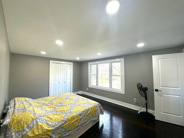 bedroom featuring dark hardwood / wood-style flooring and a closet