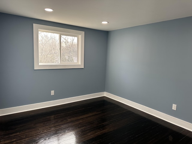 empty room with dark hardwood / wood-style floors