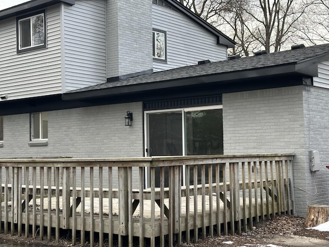 rear view of property featuring a wooden deck