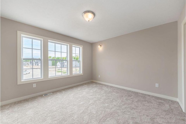 unfurnished room with light colored carpet