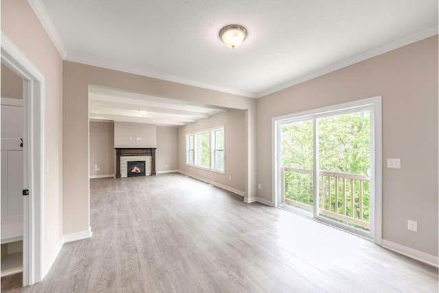 unfurnished living room with crown molding, a fireplace, and light hardwood / wood-style floors