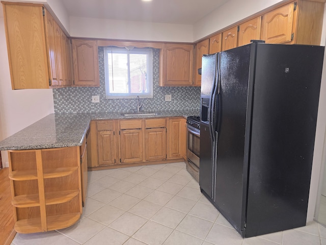 kitchen featuring tasteful backsplash, sink, black refrigerator with ice dispenser, and gas stove